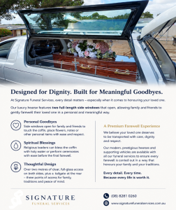 Silver Signature Funeral Services hearse with glass side panels and floral arrangement, parked in cemetery grounds for a dignified funeral service.