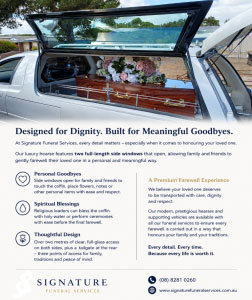 Silver Signature Funeral Services hearse with glass side panels and floral arrangement, parked in cemetery grounds for a dignified funeral service.